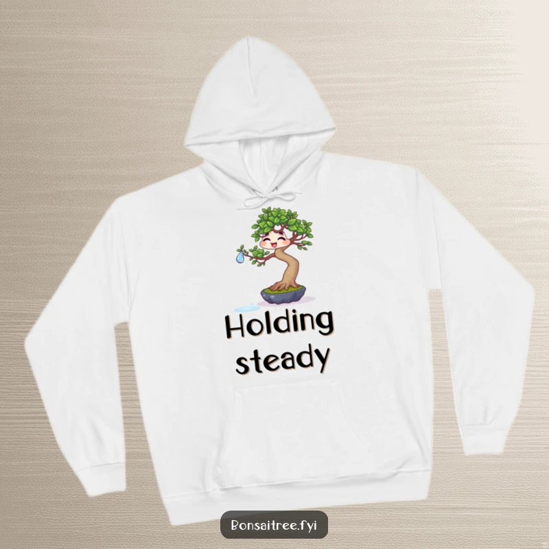 Funny giggling bonsai balancing a water droplet on a leaf on a hoodie, offering cozy comfort and a touch of humorous precision.