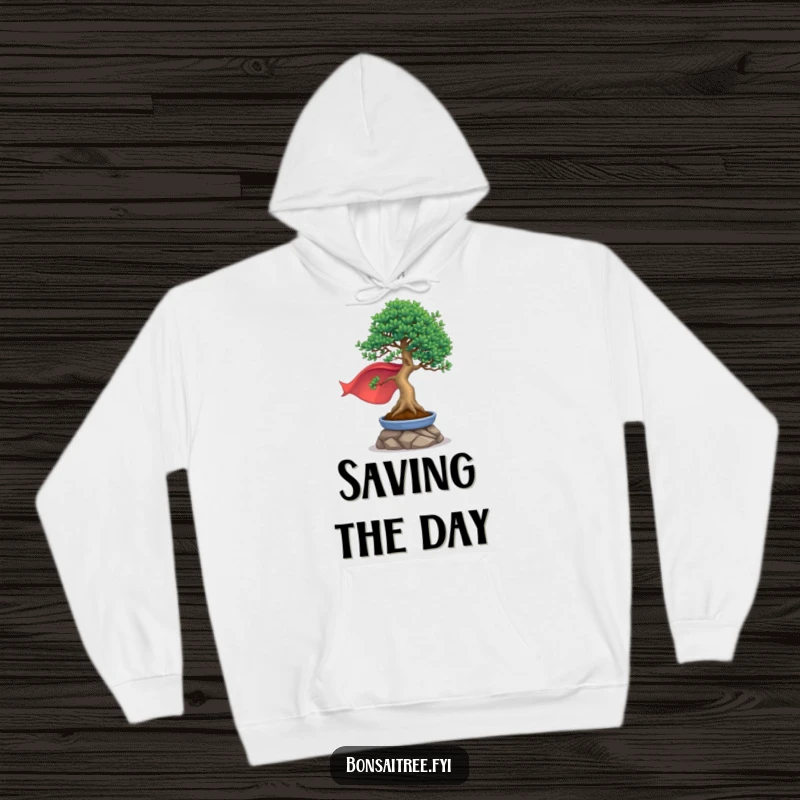 Funny, cozy hoodie of a bonsai tree wearing a cape and striking a heroic pose, embodying bravery and strength.
