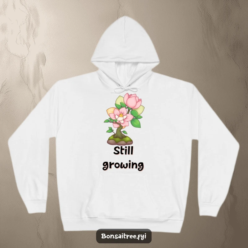 Funny shy bonsai peeking from behind a flower on a hoodie, offering cozy comfort and sweet, gentle humor.